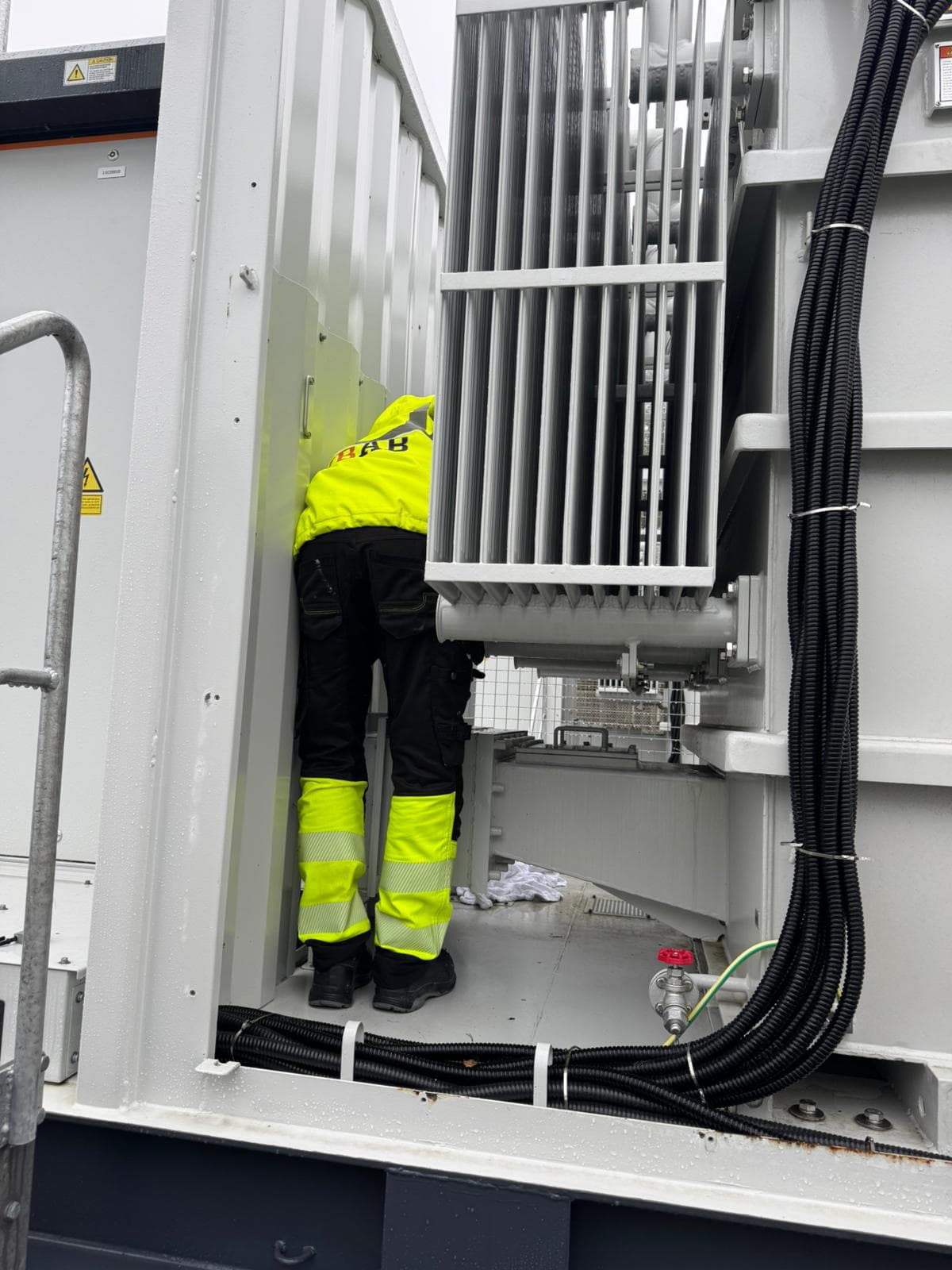 Technician inspecting the interior of a battery container